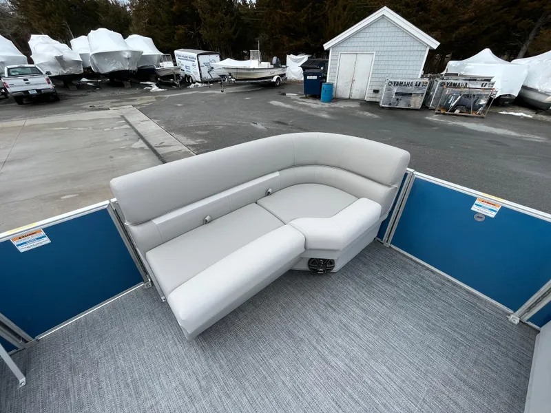 Slide: The Image of 2025 Godfrey Xperience Cruise boat with gray seating, parked in a marina. - 10