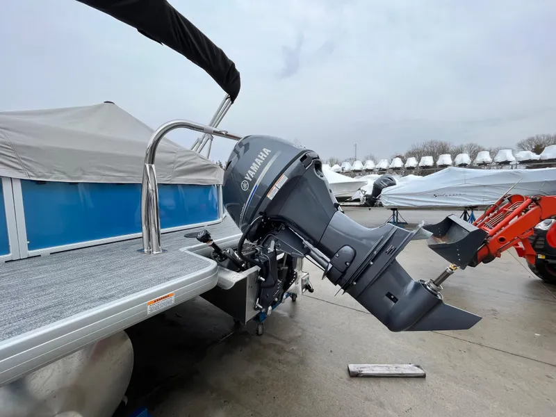 Slide: The Image of 2025 Godfrey Xperience Cruise boat with Yamaha outboard motor, docked on a cloudy day. - 11