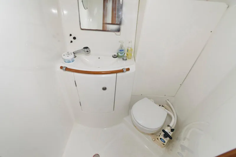 Slide: The Image of Bathroom interior of 2002 Beneteau 393 yacht, featuring sink and toilet. - 14