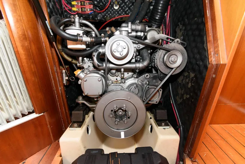 Slide: The Image of Engine compartment of a 2002 Beneteau 393 sailboat, showcasing mechanical components and belts. - 17