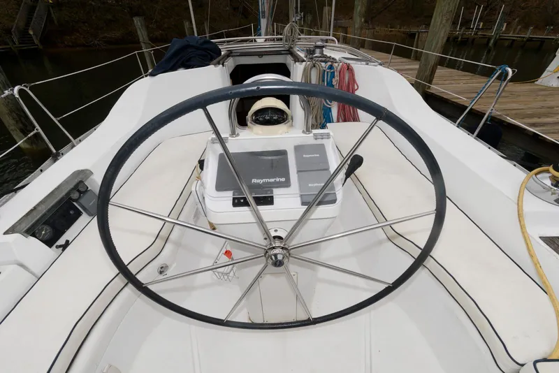 Slide: The Image of 2002 Beneteau 393 sailboat cockpit with steering wheel and navigation equipment. - 3