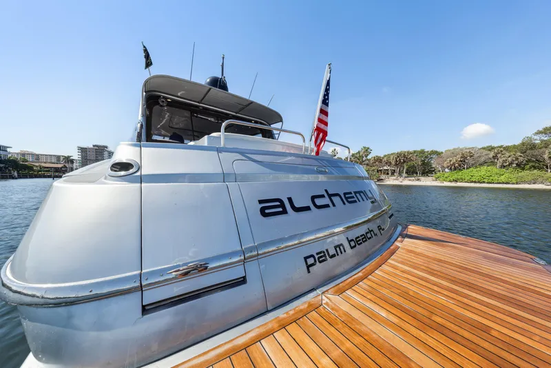 Slide: The Image of 2003 Baia PANTHER 80 yacht docked, featuring sleek design and American flag. - 12
