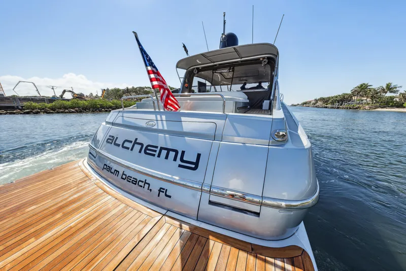 Slide: The Image of Luxury 2003 Baia Panther 80 yacht with American flag, docked in Palm Beach, FL. - 13