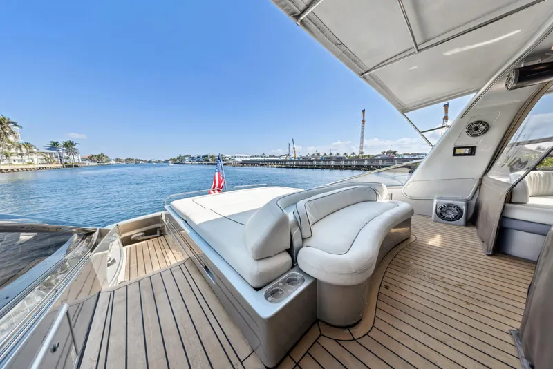 Slide: The Image of Luxurious 2003 Baia Panther 80 yacht deck with elegant seating and scenic waterfront view. - 14