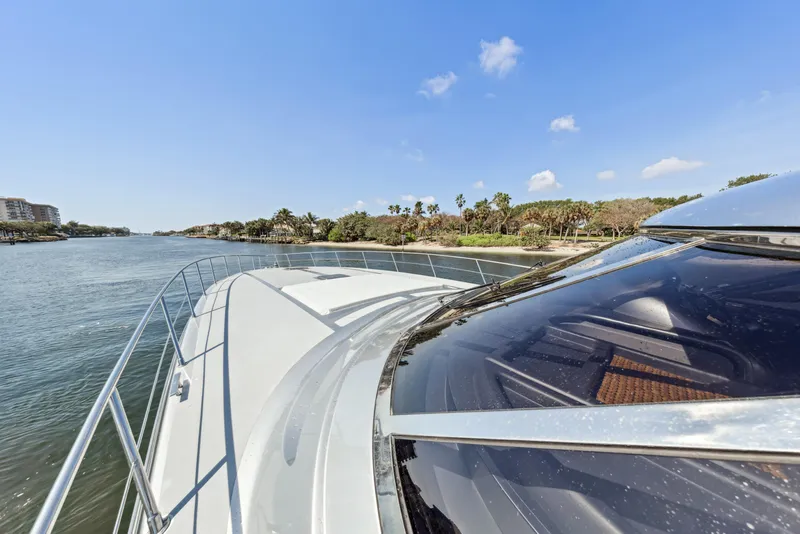 Slide: The Image of Luxury Baia PANTHER 80 yacht cruising along a scenic coastline, 2003 model. - 21