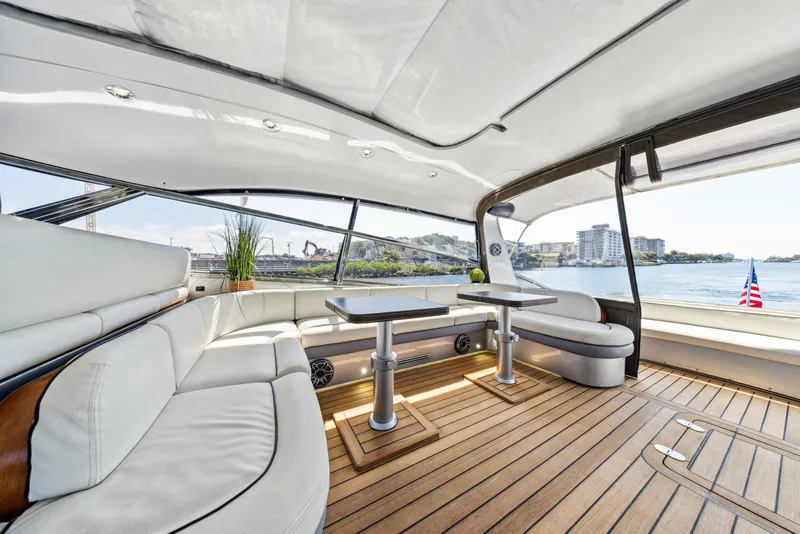 Slide: The Image of Luxurious 2003 Baia Panther 80 yacht interior with elegant seating and scenic water views. - 27