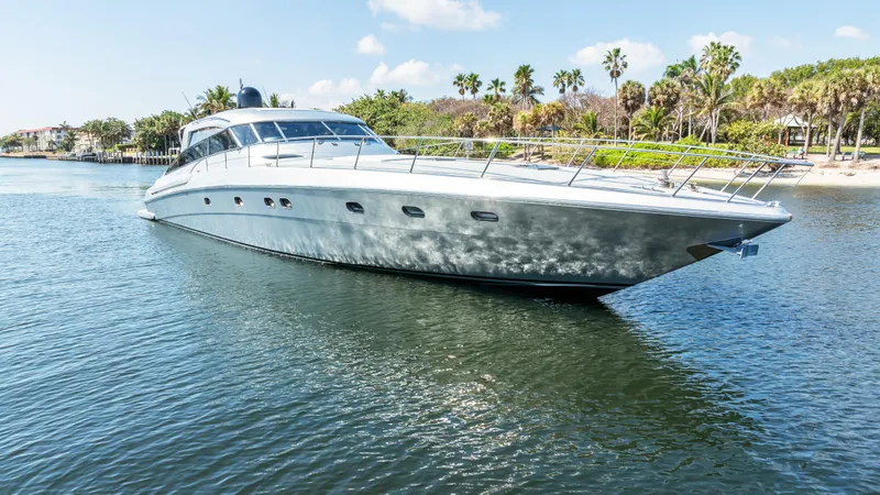 Slide: The Image of Luxury 2003 Baia Panther 80 yacht cruising on a sunny day near a tropical shoreline. - 3