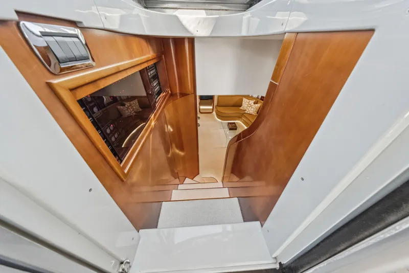 Slide: The Image of Interior view of 2003 Baia Panther 80 yacht, featuring wooden paneling and a cozy seating area. - 37
