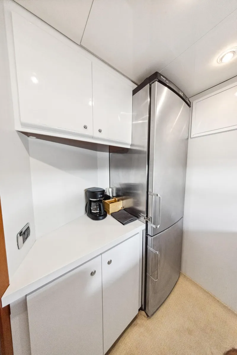 Slide: The Image of Compact kitchen area in a 2003 Baia PANTHER 80 yacht with modern appliances. - 46