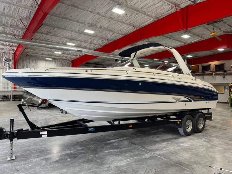Slide: The Image of 2000 Sea Ray 280 BR boat on trailer in a spacious indoor facility. - 1
