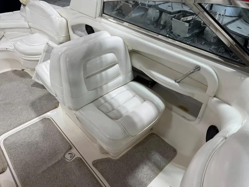Slide: The Image of 2000 Sea Ray 280 BR boat interior with white seating and carpeted flooring. - 10