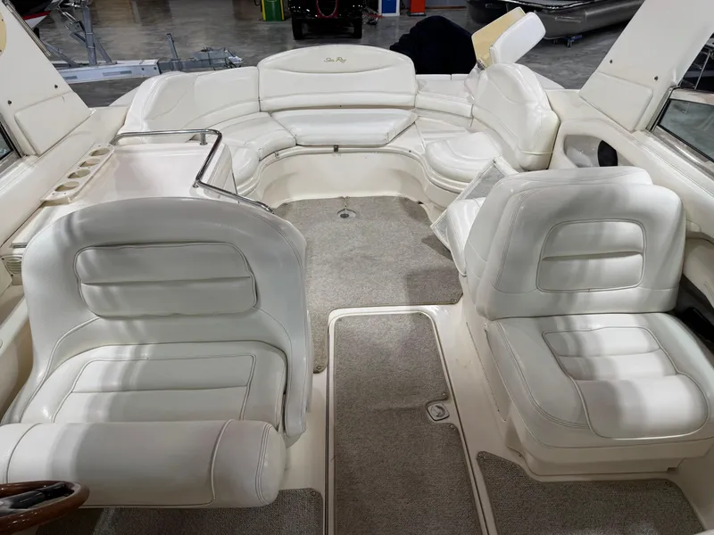Slide: The Image of 2000 Sea Ray 280 BR boat interior with white seating and carpeted floor. - 11