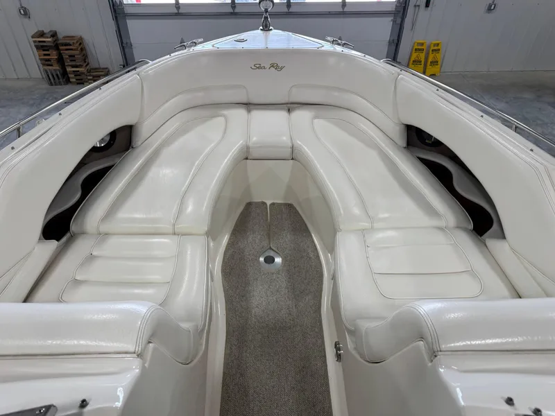 Slide: The Image of 2000 Sea Ray 280 BR boat interior with white leather seating and carpeted floor. - 12