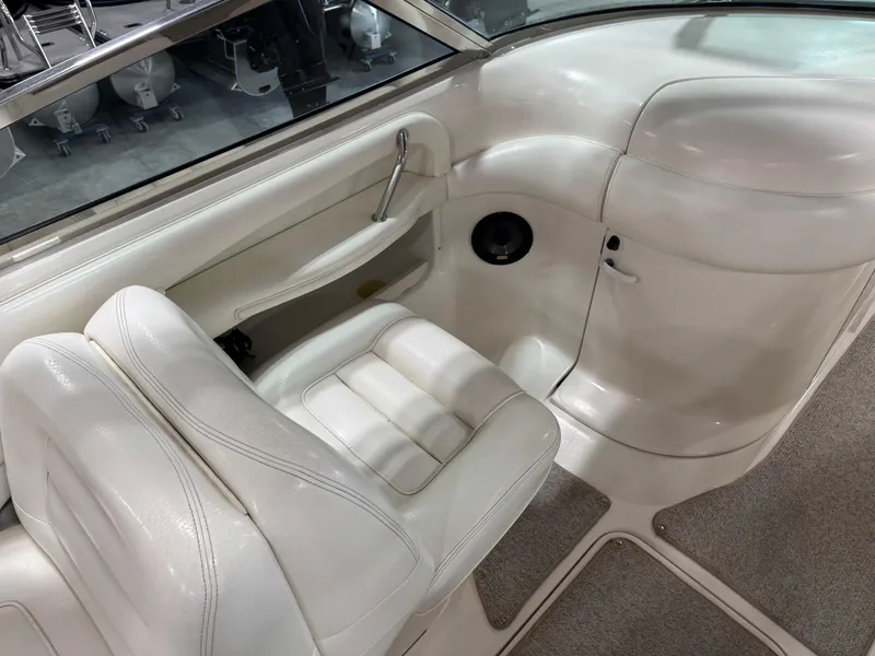 Slide: The Image of 2000 Sea Ray 280 BR boat interior with white seating and carpeted flooring. - 13