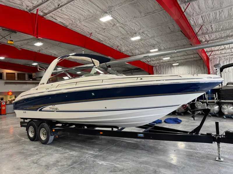Slide: The Image of 2000 Sea Ray 280 BR boat on trailer in indoor storage facility. - 2