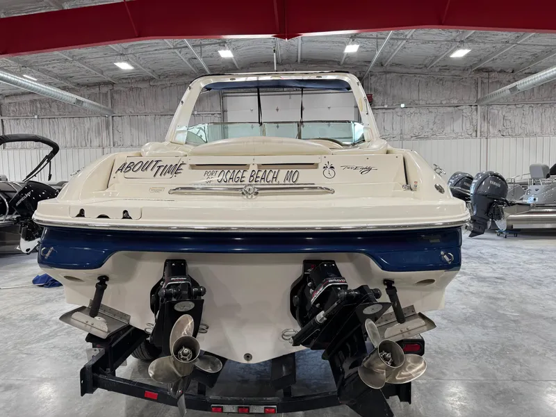 Slide: The Image of 2000 Sea Ray 280 BR boat in a warehouse, rear view with dual propellers. - 5