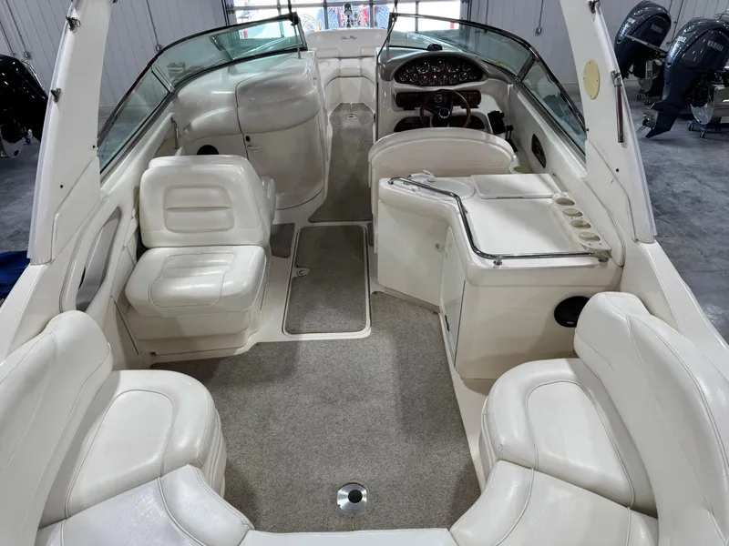 Slide: The Image of 2000 Sea Ray 280 BR boat interior with white seating and carpeted floor. - 7