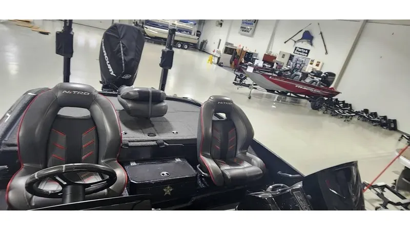 Slide: The Image of 2019 Nitro Z20 boat interior in showroom with steering wheel and seats. - 11
