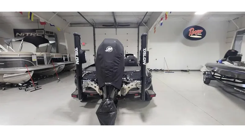 Slide: The Image of 2019 Nitro Z20 boat in showroom, covered engine, surrounded by other boats. - 14