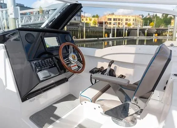 Slide: The Image of 2026 Solara S-250 DC boat cockpit with modern controls and wooden steering wheel. - 10