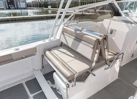 Slide: The Image of Luxury seating on 2026 Solara S-250 DC boat, docked by the water. - 15