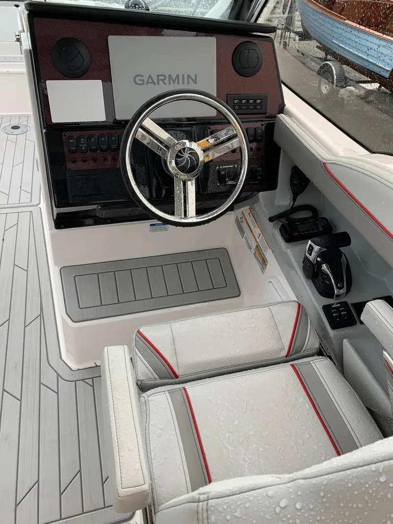 Slide: The Image of 2026 Solara S-250 DC boat cockpit with Garmin navigation system and sleek steering wheel. - 17