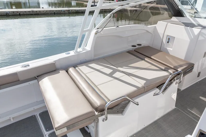 Slide: The Image of 2026 Solara S-250 DC boat interior with beige seating, dockside view. - 18