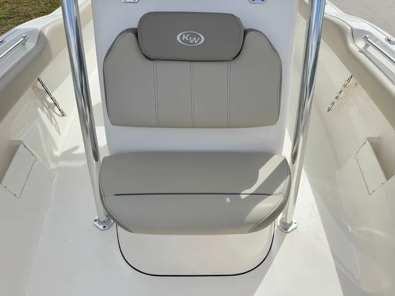 Slide: The Image of 2023 Key West 239 FS boat seat with beige cushions and stainless steel supports. - 11