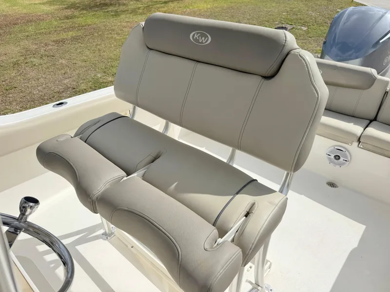 Slide: The Image of 2023 Key West 239 FS boat seat with beige upholstery and KW logo. - 14