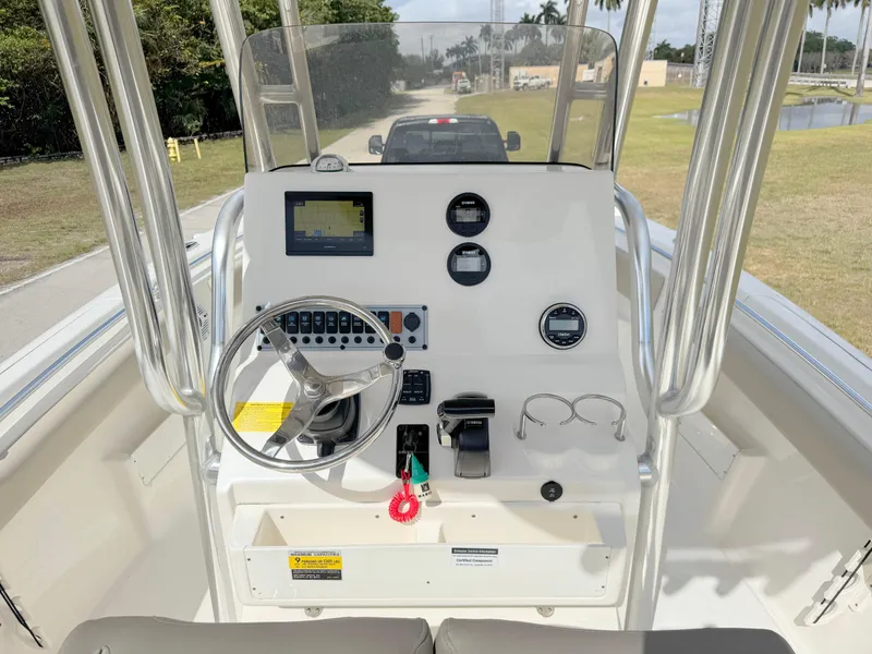 Slide: The Image of 2023 Key West 239 FS boat console with steering wheel and navigation instruments. - 16