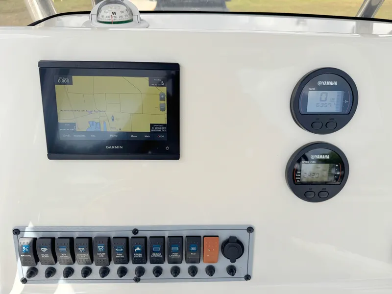 Slide: The Image of 2023 Key West 239 FS boat dashboard with Garmin display and Yamaha gauges. - 18