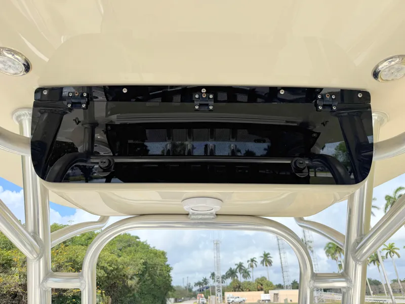 Slide: The Image of 2023 Key West 239 FS boat console with overhead storage and clear sky background. - 19