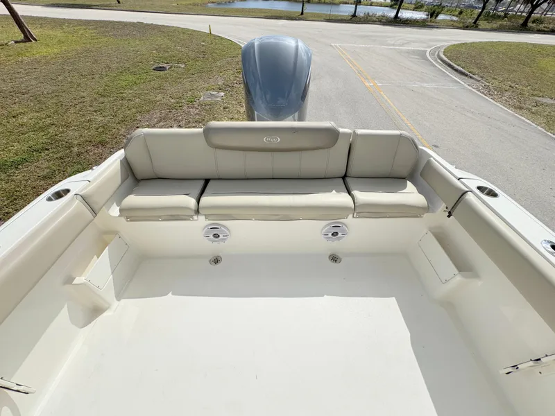 Slide: The Image of 2023 Key West 239 FS boat interior with cushioned seating and clean deck. - 20