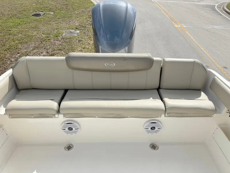 Slide: The Image of 2023 Key West 239 FS boat with cushioned seating and dual speakers. - 21