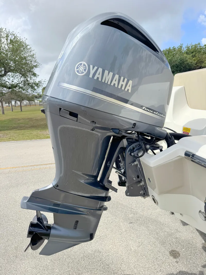 Slide: The Image of 2023 Key West 239 FS boat with Yamaha outboard motor, parked outdoors. - 28