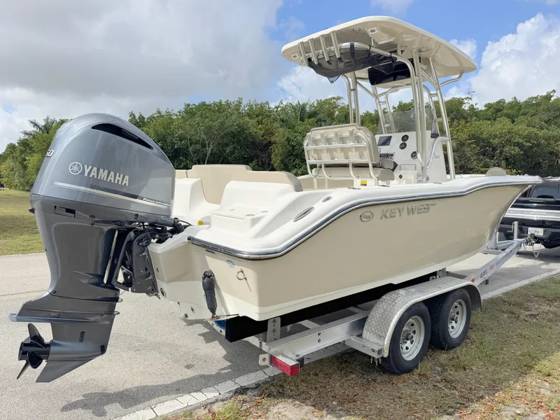 Slide: The Image of 2023 Key West 239 FS boat on trailer with Yamaha outboard motor, parked outdoors. - 4