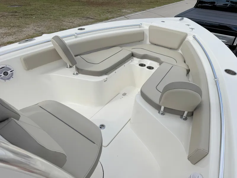 Slide: The Image of 2023 Key West 239 FS boat interior with cushioned seating and cup holders. - 8