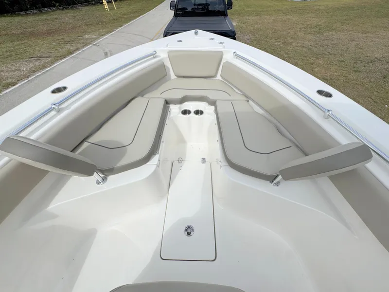 Slide: The Image of 2023 Key West 239 FS boat interior with cushioned seating and cup holders. - 9