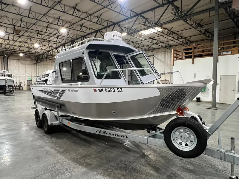 Slide: The Image of 2022 Hewescraft 210 Sea Runner ET HT boat on trailer in warehouse. - 12