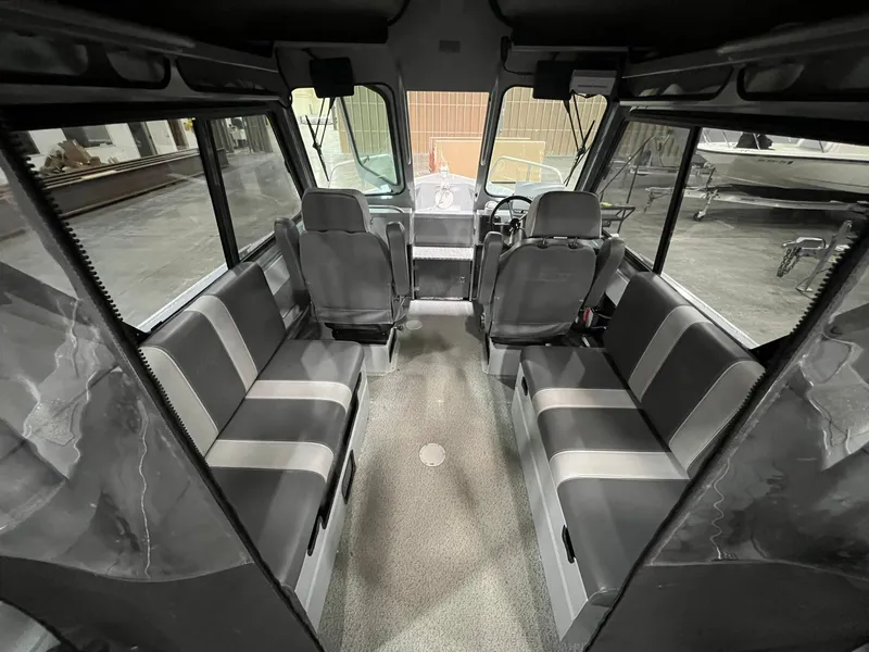 Slide: The Image of 2022 Hewescraft 210 Sea Runner ET HT interior with seating and steering wheel. - 17