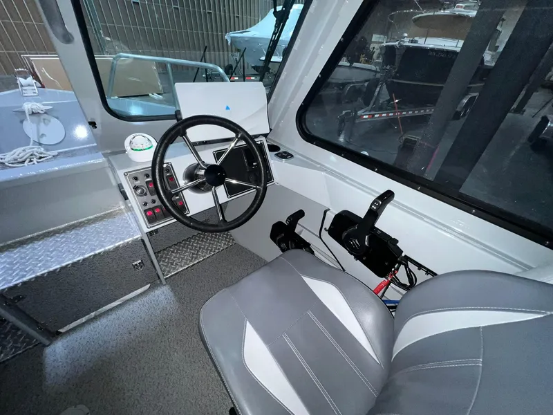 Slide: The Image of 2022 Hewescraft 210 Sea Runner ET HT boat interior with steering wheel and controls. - 19