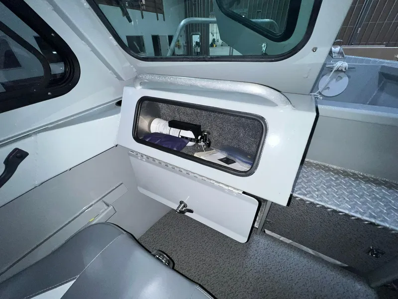 Slide: The Image of Interior of 2022 Hewescraft 210 Sea Runner ET HT boat, featuring storage compartment. - 20