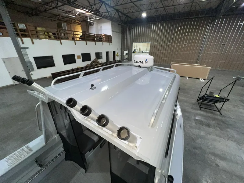 Slide: The Image of 2022 Hewescraft 210 Sea Runner ET HT boat in warehouse, featuring Garmin equipment. - 24