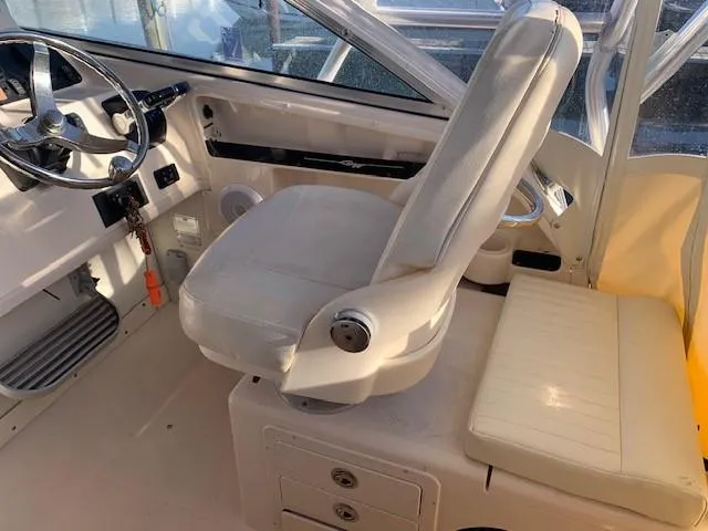 Slide: The Image of 2006 Grady-White Marlin 300 boat interior with captain's chair and steering wheel. - 11