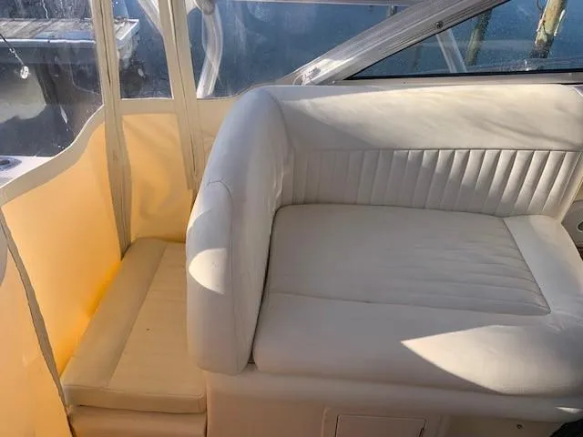 Slide: The Image of 2006 Grady-White Marlin 300 boat interior with white cushioned seating. - 19