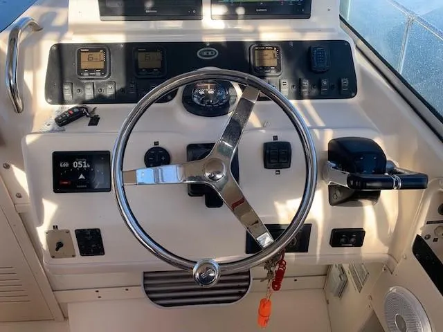 Slide: The Image of 2006 Grady-White Marlin 300 helm with steering wheel and control panel. - 9