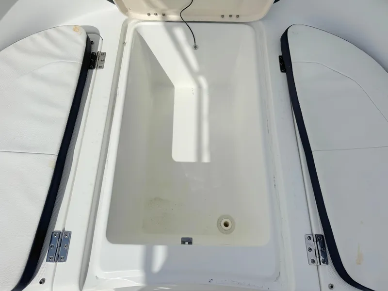 Slide: The Image of Open storage compartment on 2016 Clearwater 2200 WI Center Console boat. - 11