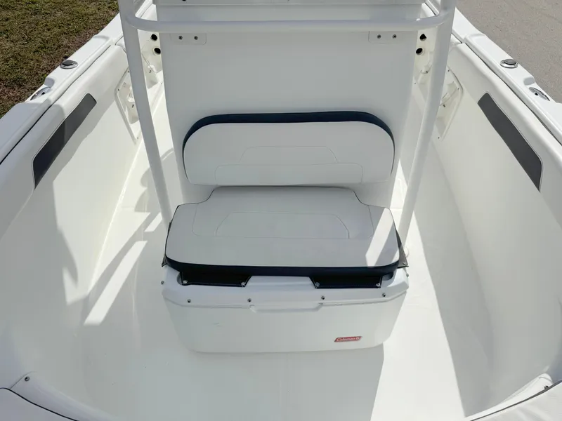 Slide: The Image of 2016 Clearwater 2200 WI Center Console boat interior with white seating and storage. - 12