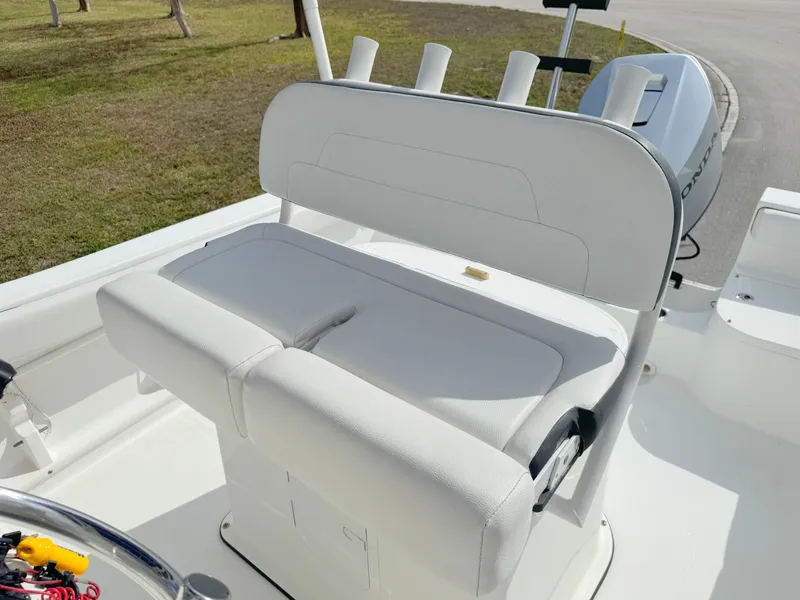 Slide: The Image of 2016 Clearwater 2200 WI Center Console boat seat with rod holders and outboard motor. - 14