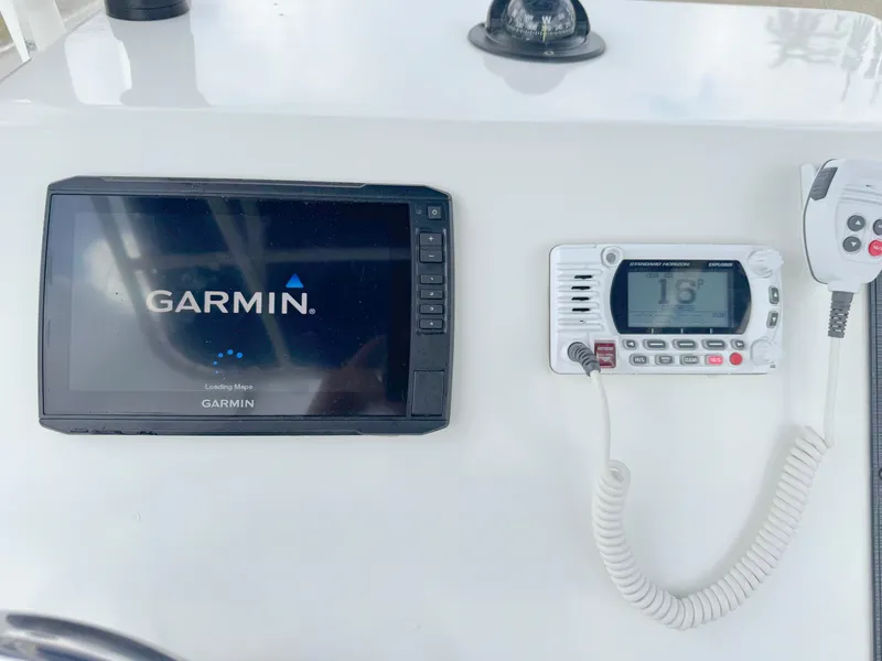 Slide: The Image of Garmin navigation system and radio on 2016 Clearwater 2200 WI Center Console boat. - 18